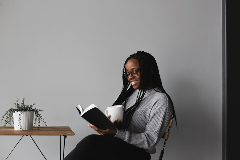woman-in-white-and-black-stripe-long-sleeve-shirt-sitting-on-chair-wkgv7i2vtzm